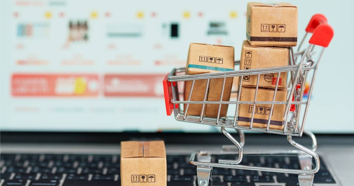 Boxes with shopping cart on a laptop computer. online shopping, Marketplace platform website, technology, ecommerce, shipping delivery, logistics and online payment concepts | How Can I Create An E-commerce Website That Maximises Sales